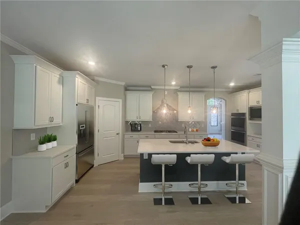 a kitchen with stainless steel appliances granite countertop a stove microwave and refrigerator