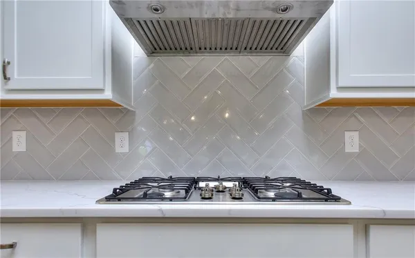 wooden floor fireplace and windows in an empty room