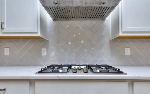 wooden floor fireplace and windows in an empty room