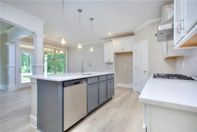 a spacious bathroom with a granite countertop sink a mirror and a bathtub