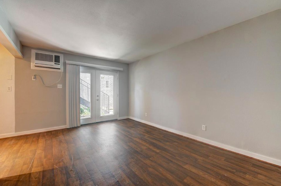 2322 Dunlavy Street, Unit 6 Houston, TX 77006 - Photo 1 of 6 a view of an empty room with wooden floor and a window