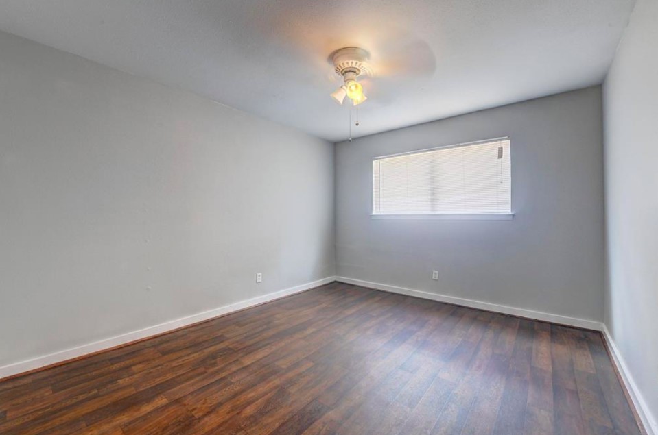 2322 Dunlavy Street, Unit 6 Houston, TX 77006 - Photo 5 of 6 an empty room with wooden floor and windows