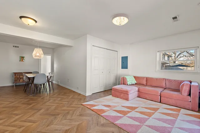 a living room with furniture and a dining table