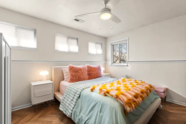 a bedroom with a bed and a chandelier