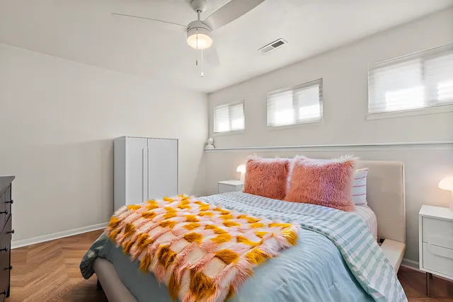 a bedroom with a large bed and a chandelier