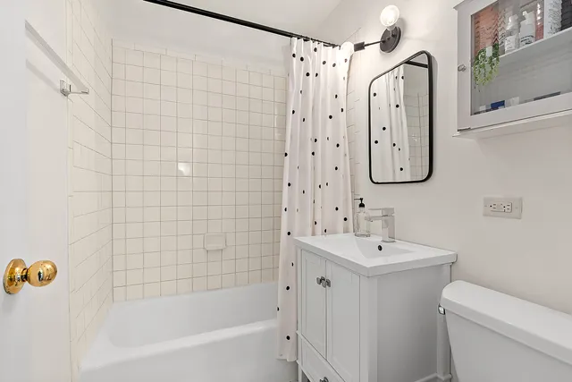 a bathroom with a sink mirror toilet and bathtub