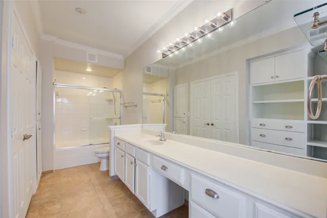 a spacious bathroom with a double vanity sink a mirror and a bathtub