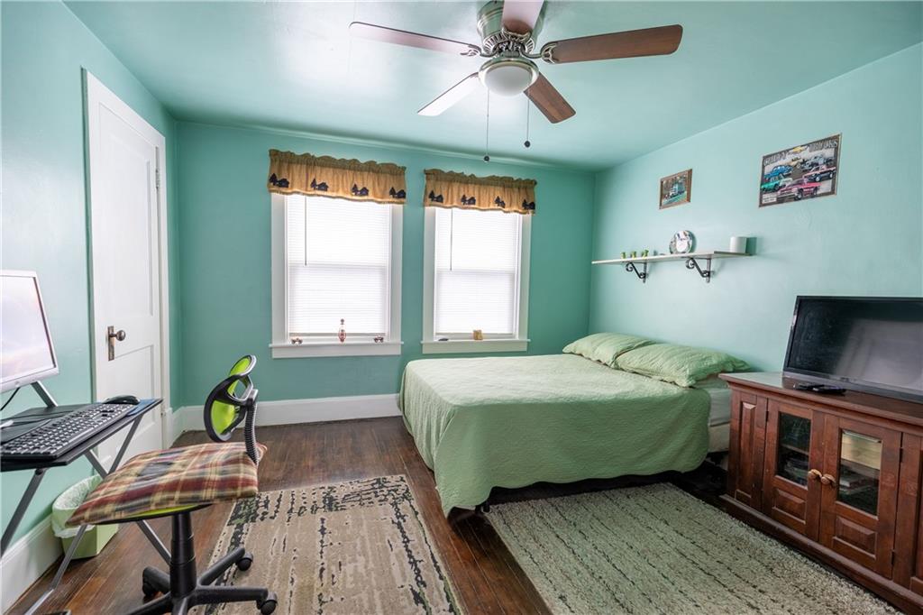 626 West Main Street Everett, PA 15537 - Photo 17 of 32 a bedroom with a bed and a chandelier