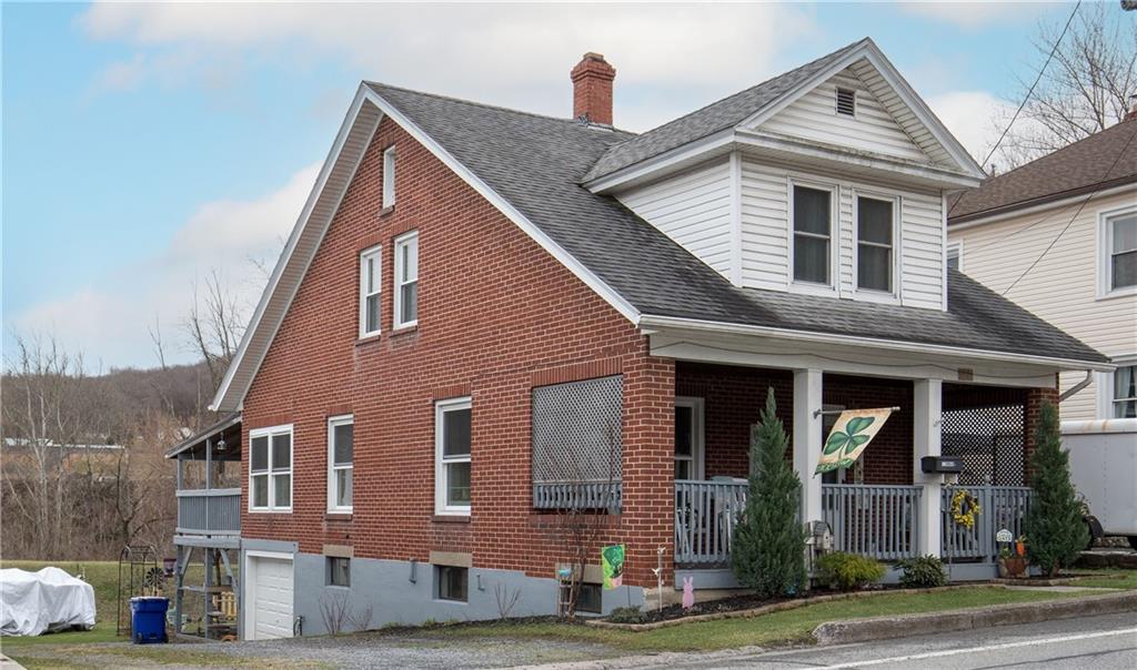 626 West Main Street Everett, PA 15537 - Photo 2 of 32 a front view of a house with a yard