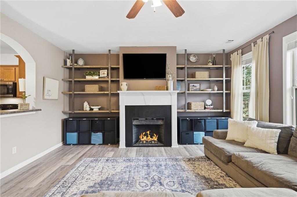 615 Myers Gate Road Ball Ground, GA 30107 - Photo 6 of 43 a living room with furniture fireplace and flat screen tv
