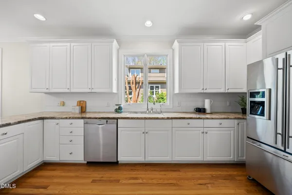 a kitchen with stainless steel appliances granite countertop a sink and cabinets