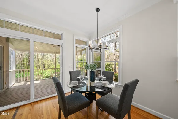 a view of a dining room with furniture window and wooden floor