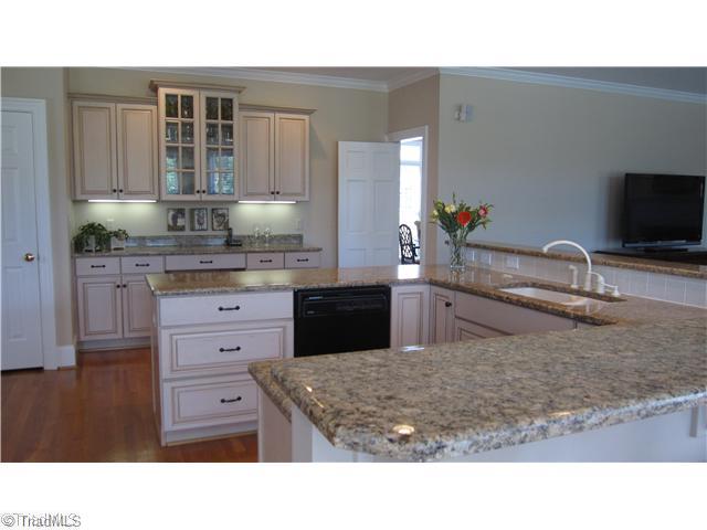5702 Wolf Ridge Court Oak Ridge, NC 27310 - Photo 4 of 16 Kitchen. Kitchen is a cooks dream, with Oven plus convection microwave and lots of granite couner tops.