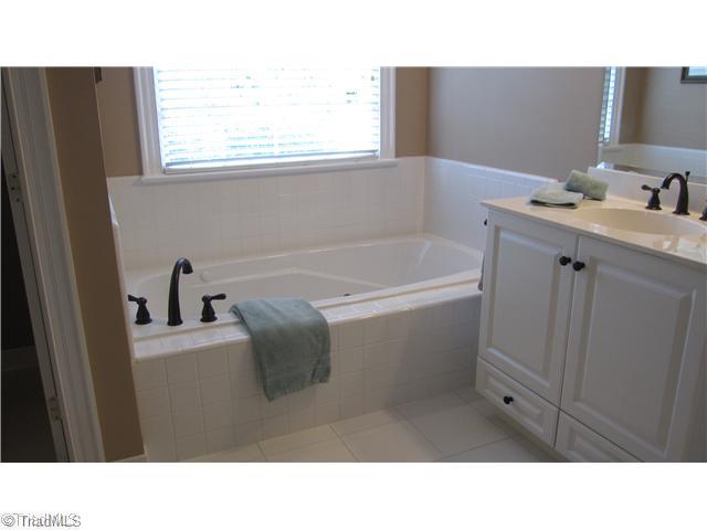 5702 Wolf Ridge Court Oak Ridge, NC 27310 - Photo 9 of 16 Master Bath/Spa. Master bath has jetted tub, his and her sinks, upgraded fixtures and separate shower