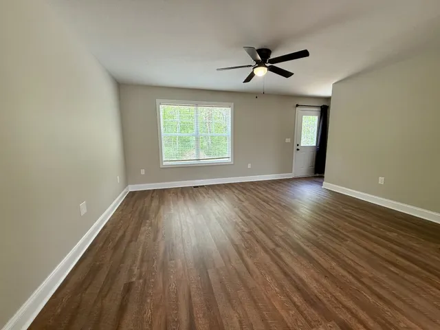 wooden floor in an empty room with a window