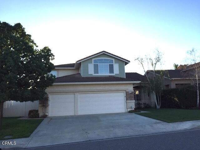 1673 Paseo Castille Camarillo, CA 93010 - Photo 2 of 20 a front view of a house with a yard and garage