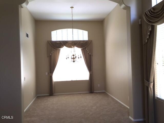1673 Paseo Castille Camarillo, CA 93010 - Photo 9 of 20 an empty room with a chandelier