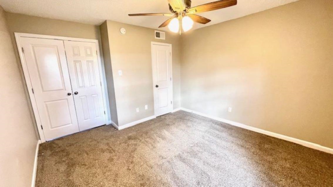4704 Bill Knight Road Millington, TN 38053 - Photo 11 of 17 Unfurnished bedroom with carpet flooring, a closet, and ceiling fan