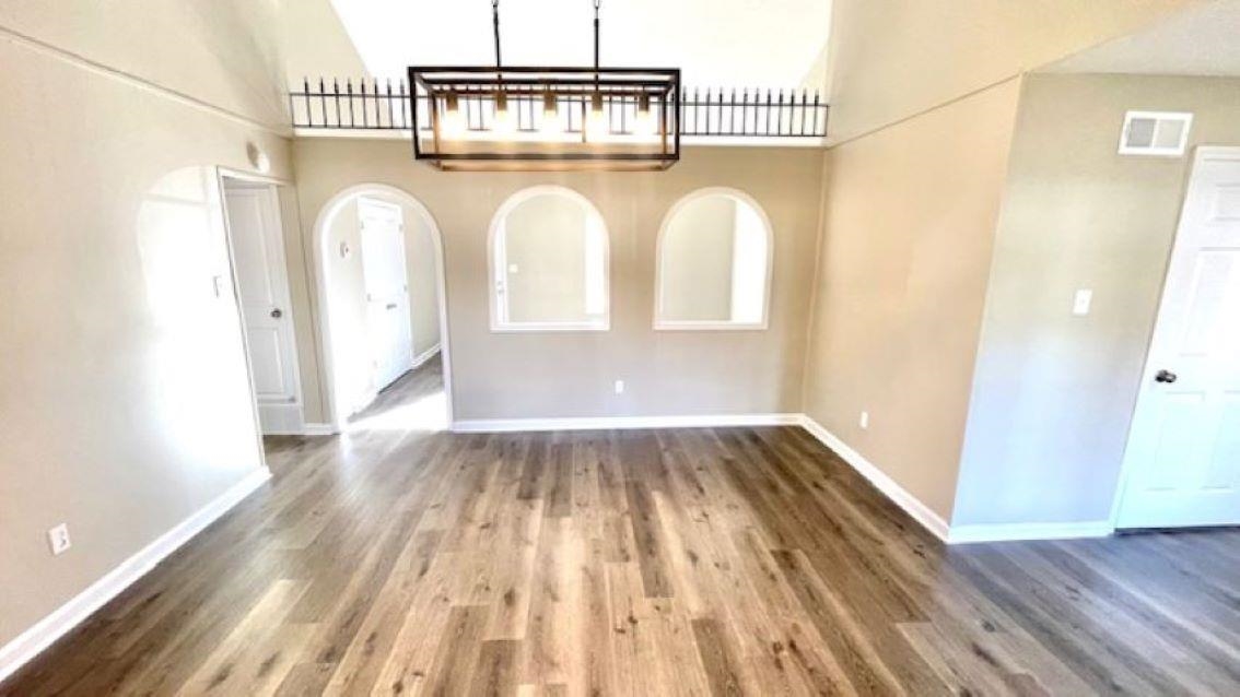 4704 Bill Knight Road Millington, TN 38053 - Photo 3 of 17 Unfurnished dining area featuring a towering ceiling and dark hardwood / wood-style floors