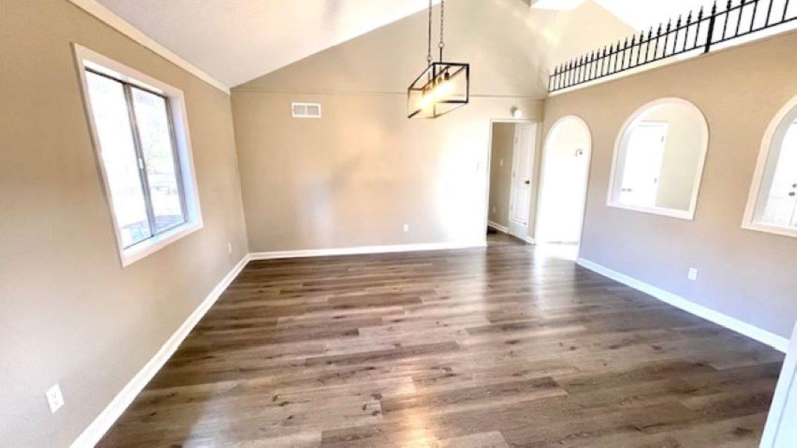 4704 Bill Knight Road Millington, TN 38053 - Photo 7 of 17 Unfurnished dining area with dark hardwood / wood-style floors and high vaulted ceiling