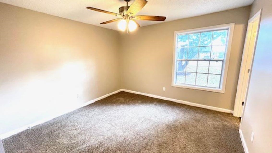 4704 Bill Knight Road Millington, TN 38053 - Photo 8 of 17 Spare room featuring dark colored carpet and ceiling fan