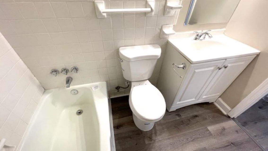 4704 Bill Knight Road Millington, TN 38053 - Photo 10 of 17 Bathroom with vanity, wood-type flooring, tile walls, and toilet
