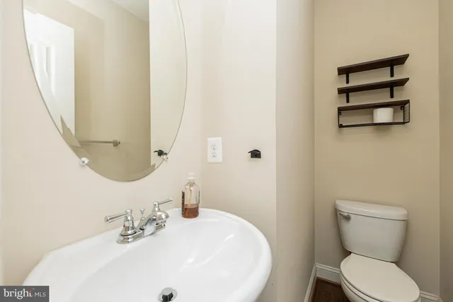 a white toilet sitting next to a bathroom sink