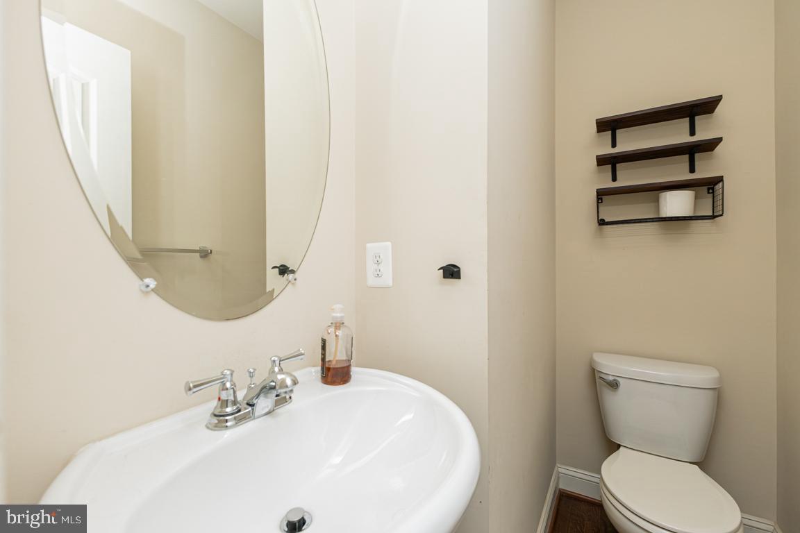 4511 Potomac Highlands Circle Triangle, VA 22172 - Photo 20 of 31 a white toilet sitting next to a bathroom sink