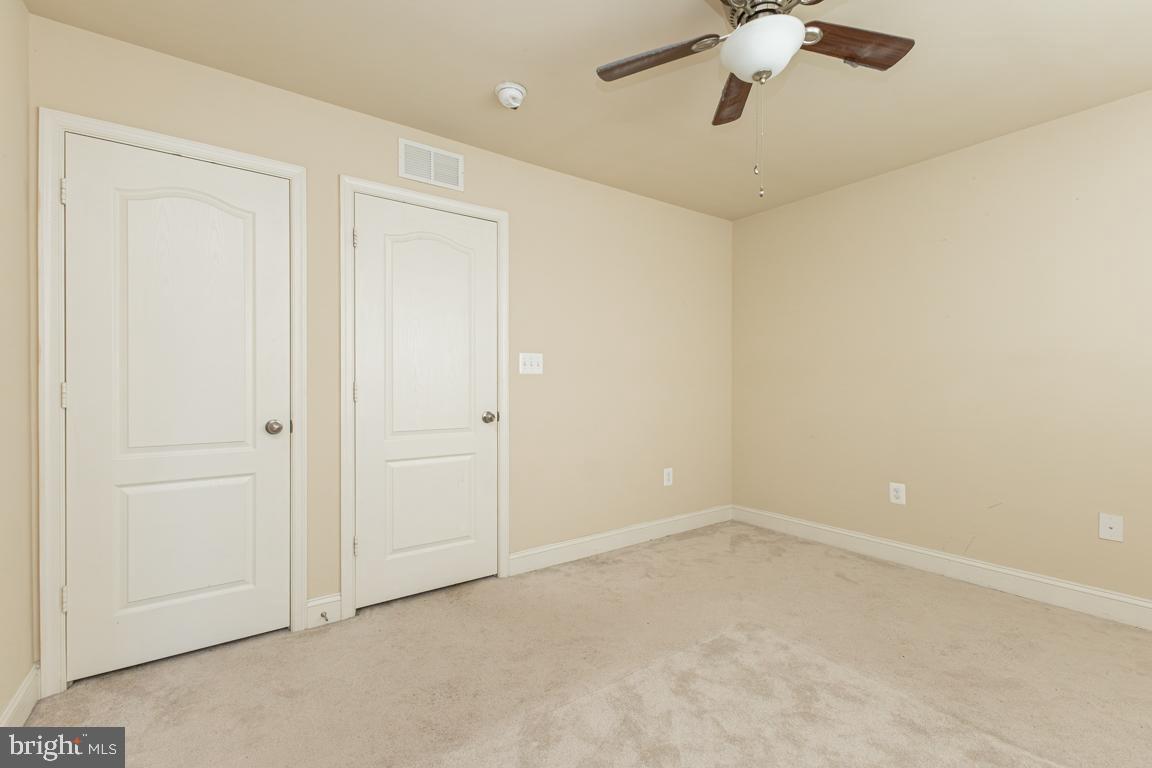 4511 Potomac Highlands Circle Triangle, VA 22172 - Photo 22 of 31 an empty room with a chandelier fan