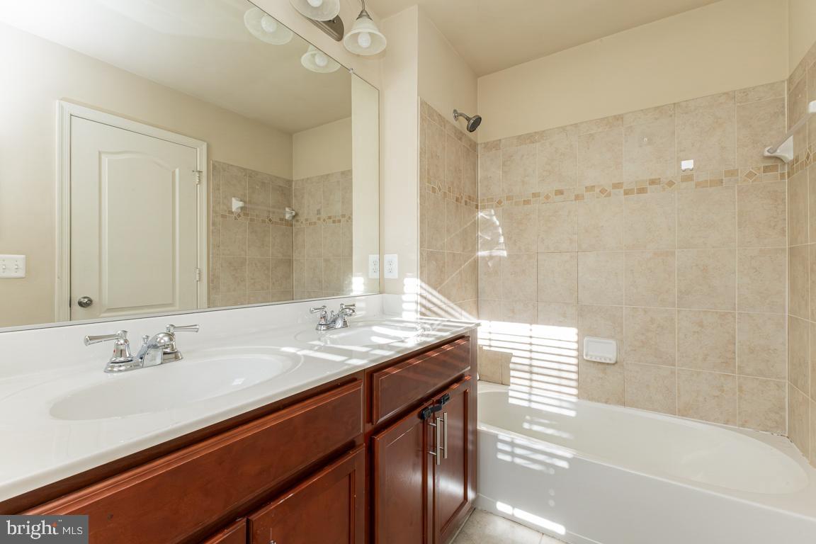 4511 Potomac Highlands Circle Triangle, VA 22172 - Photo 10 of 31 a bathroom with a sink and a mirror