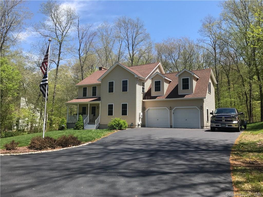 104 Church Hill Road Ledyard, CT 06339 - Photo 1 of 1 a front view of a house with a garden and trees
