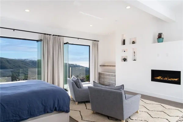 a bedroom with a bed a couch and a window