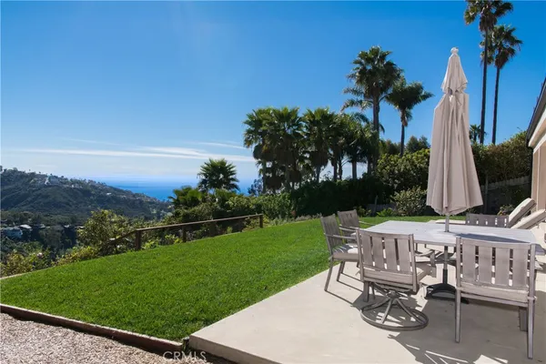 a view of a chair and table in the garden