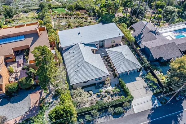 an aerial view of a house with a yard and garden