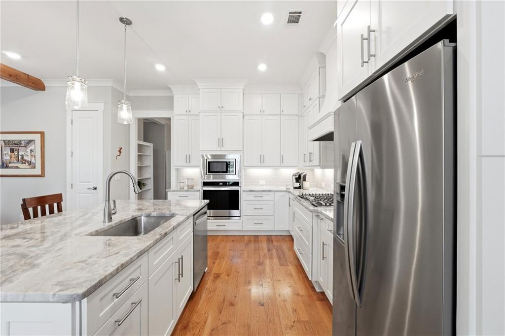 206 Trecastle Square Canton, GA 30114 - Photo 11 of 49 a kitchen with stainless steel appliances granite countertop a sink refrigerator and cabinets