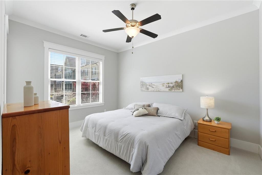 206 Trecastle Square Canton, GA 30114 - Photo 18 of 49 a bedroom with a large bed and a large window