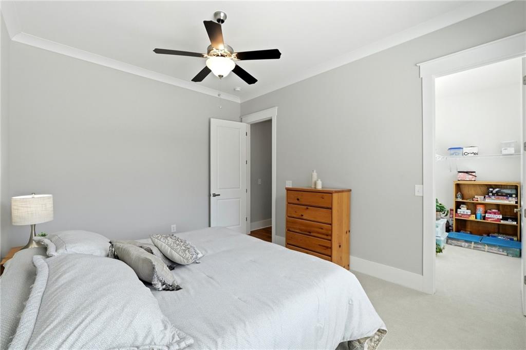 206 Trecastle Square Canton, GA 30114 - Photo 19 of 49 a bedroom with a bed and a chandelier