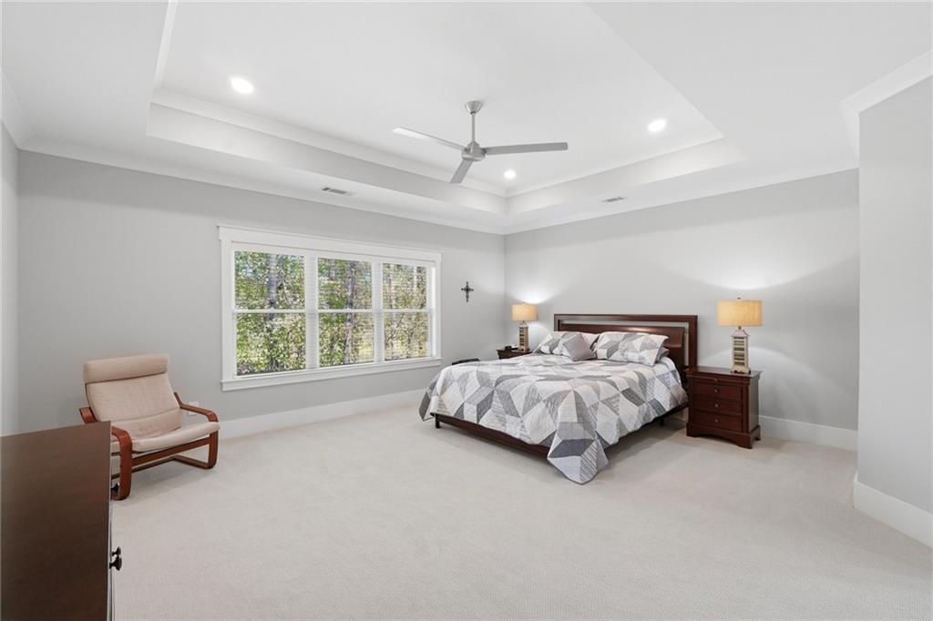 206 Trecastle Square Canton, GA 30114 - Photo 22 of 49 a bed sitting in a spacious bedroom next to a window