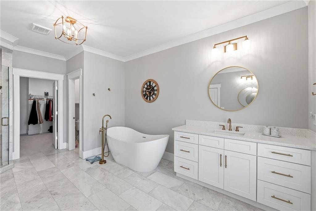 206 Trecastle Square Canton, GA 30114 - Photo 24 of 49 a spacious bathroom with a double vanity sink double mirror and a bathtub