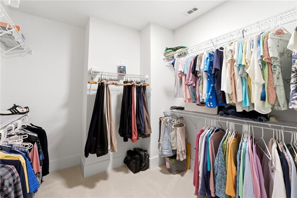206 Trecastle Square Canton, GA 30114 - Photo 27 of 49 a view of walk in closet with clothes