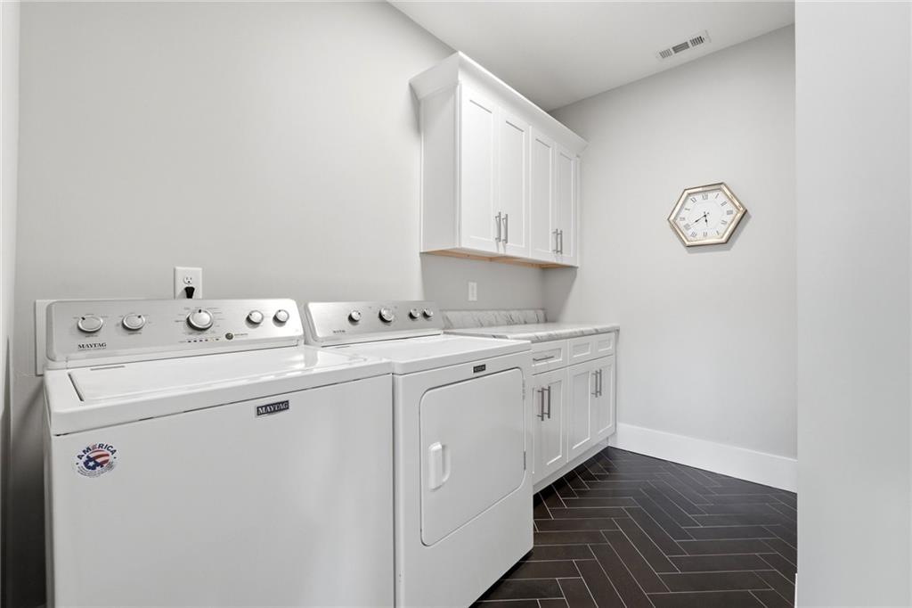 206 Trecastle Square Canton, GA 30114 - Photo 32 of 49 a utility room with cabinets washer and dryer