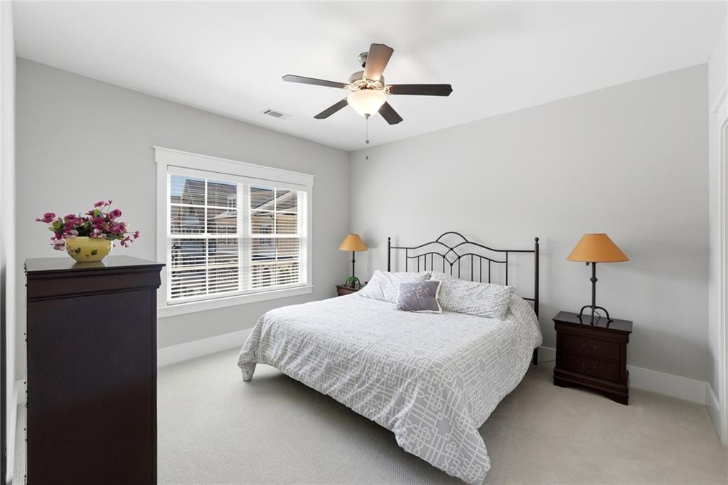 206 Trecastle Square Canton, GA 30114 - Photo 33 of 49 a bedroom with a bed and a large window