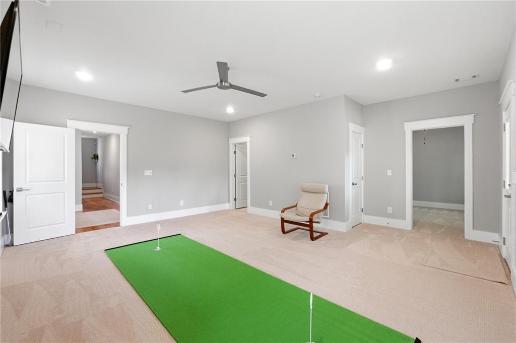 206 Trecastle Square Canton, GA 30114 - Photo 36 of 49 a view of a room with a gym equipment and a fireplace