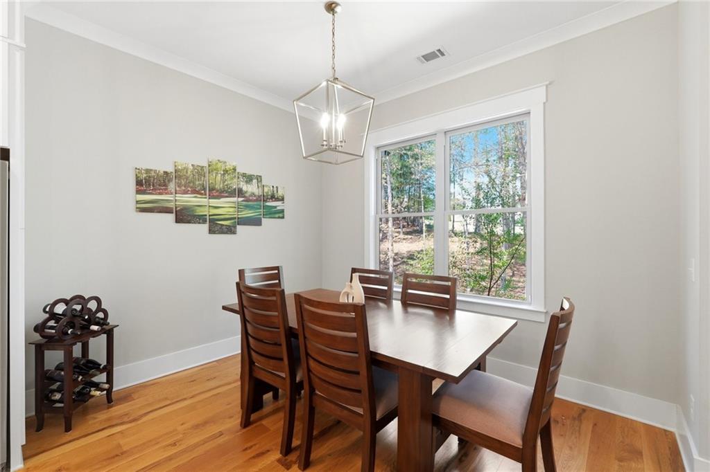 206 Trecastle Square Canton, GA 30114 - Photo 8 of 49 a view of a dining room with furniture wooden floor and chandelier