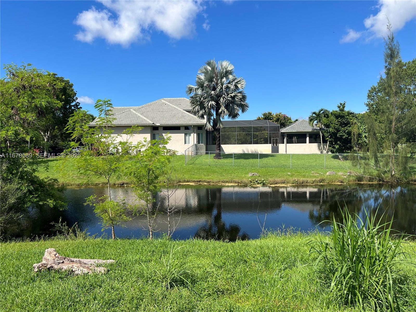 20321 Southwest 48th Street Southwest Ranches, FL 33332 - Photo 11 of 46 a view of a house with a yard