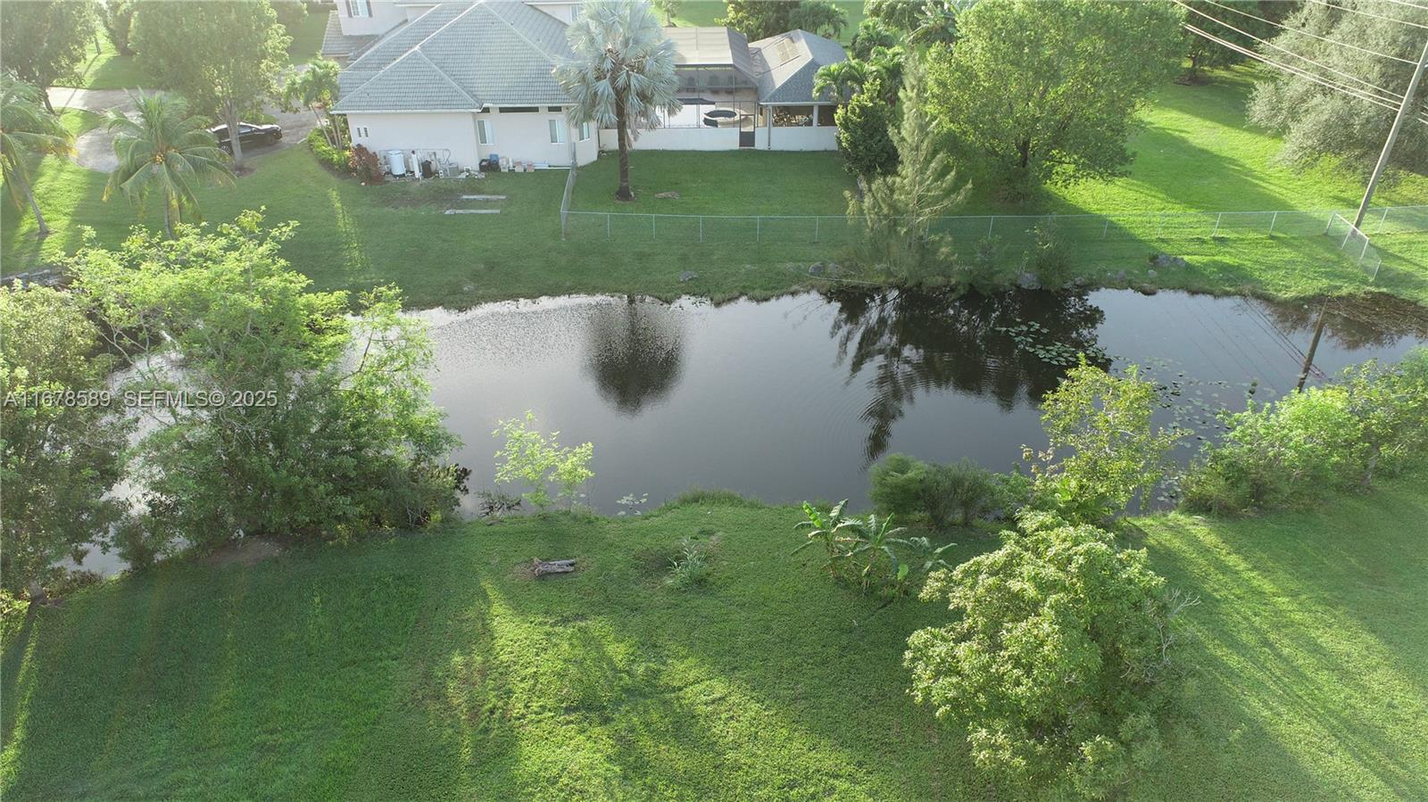 20321 Southwest 48th Street Southwest Ranches, FL 33332 - Photo 14 of 46 a view of a lake with a yard