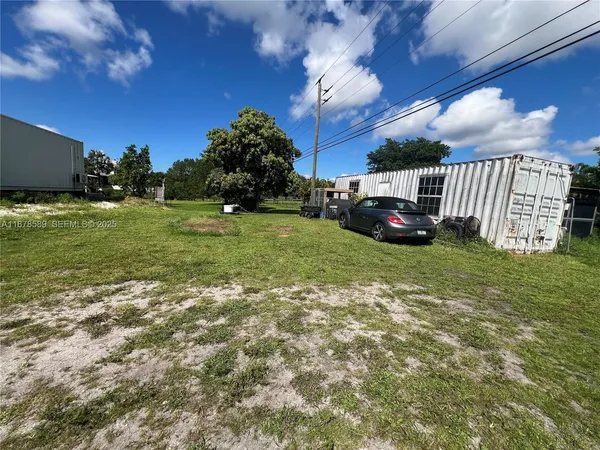 a view of a big yard with large trees