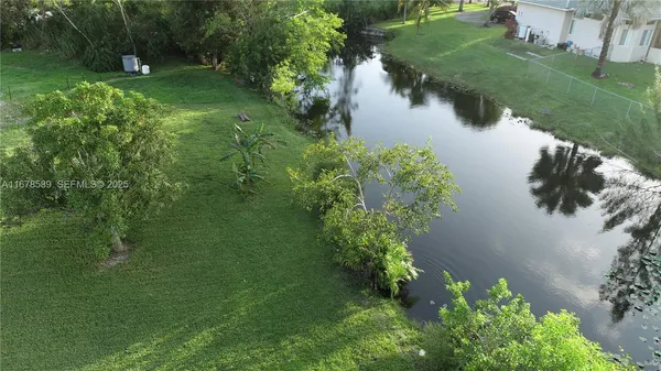 an aerial view of a house with a yard