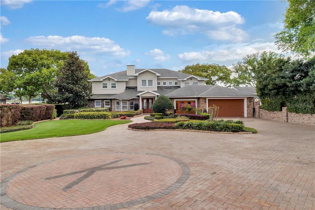 1485 Raintree Lane Mount Dora, FL 32757 - Photo 1 of 1 Front of Estate with lush landscape, mature trees, paved driveway and plenty of parking space.