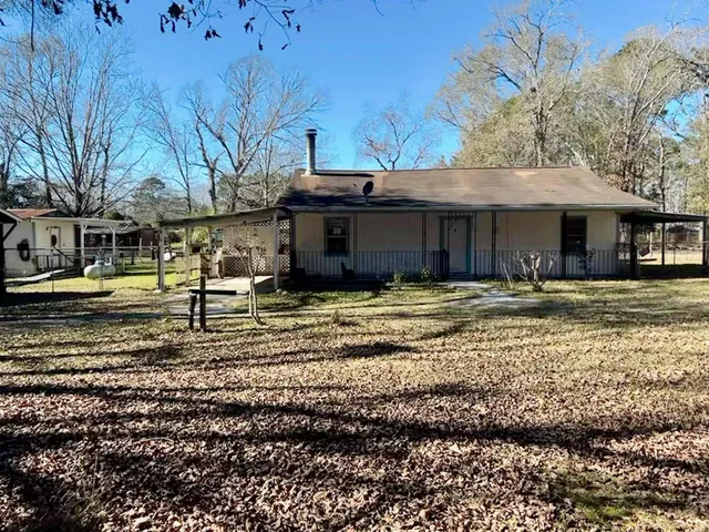 a view of a yard with large trees